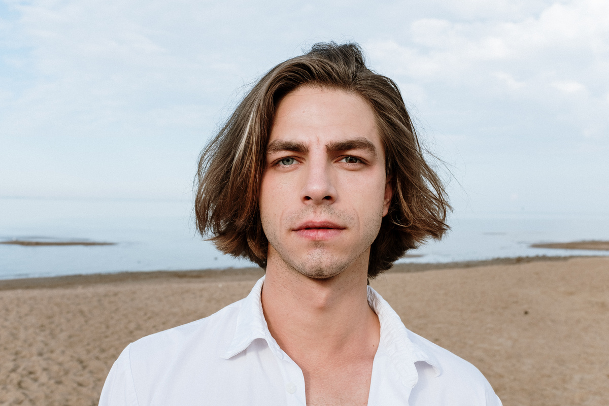 Man in White Button Up Shirt Standing on Beach